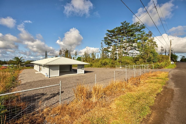 16-2075 Lilikoi Dr, Pahoa, HI 96778 - view of side of property with a metal roof