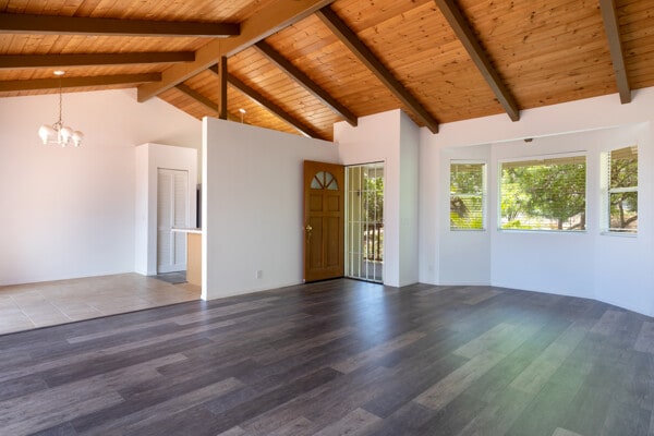 68-3750 Ua Noe Pl, Waikoloa, HI 96738 - empty room with a chandelier, wooden ceiling with exposed beams, wood finished floors, and high vaulted ceiling