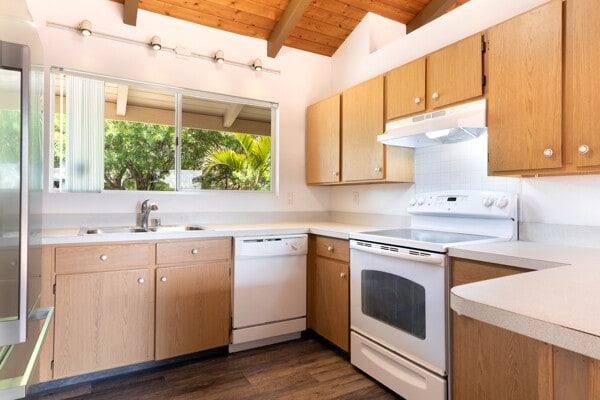68-3750 Ua Noe Pl, Waikoloa, HI 96738 - kitchen featuring white appliances, under cabinet range hood, a sink, wood ceiling, and dark wood finished floors