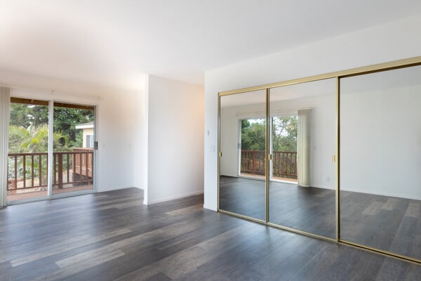 68-3750 Ua Noe Pl, Waikoloa, HI 96738 - unfurnished bedroom with access to exterior, multiple windows, and wood finished floors