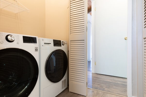 68-3750 Ua Noe Pl, Waikoloa, HI 96738 - washroom featuring washing machine and clothes dryer and wood finished floors