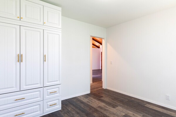 68-3750 Ua Noe Pl, Waikoloa, HI 96738 - unfurnished bedroom with dark wood-style floors, baseboards, and a closet