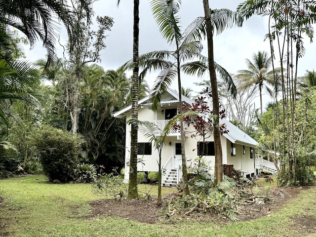 15-2015 12th Ave, Keaau, HI 96749 - view of home's exterior with a yard