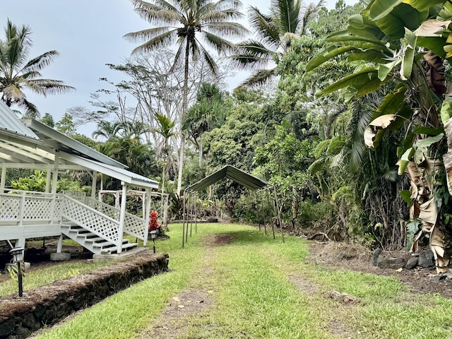 15-2015 12th Ave, Keaau, HI 96749 - view of green lawn featuring a carport and a deck
