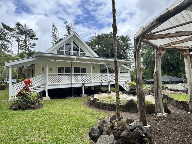 15-2015 12th Ave, Keaau, HI 96749 - rear view of house featuring a yard, a porch, and metal roof