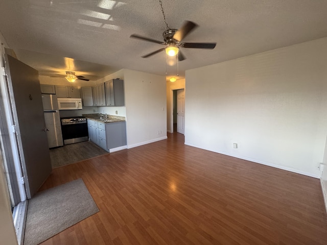 75-6008 Alii Dr Unit 234, Kailua-Kona, HI 96740 - kitchen featuring appliances with stainless steel finishes, ceiling fan, open floor plan, dark wood-type flooring, and gray cabinets