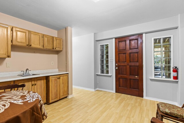 11-3827 5th St, Volcano, HI 96785 - kitchen with a sink, light countertops, light wood-style flooring, and baseboards