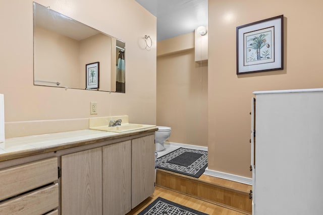 11-3827 5th St, Volcano, HI 96785 - bathroom with toilet, vanity, baseboards, and wood finished floors