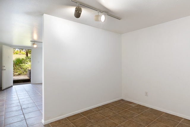 64-660 Puu Olu Pl, Kamuela, HI 96743 - unfurnished room with rail lighting and dark tile patterned floors