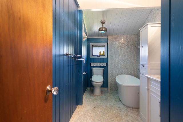64-660 Puu Olu Pl, Kamuela, HI 96743 - bathroom with a freestanding bath, wood ceiling, vanity, and tile walls