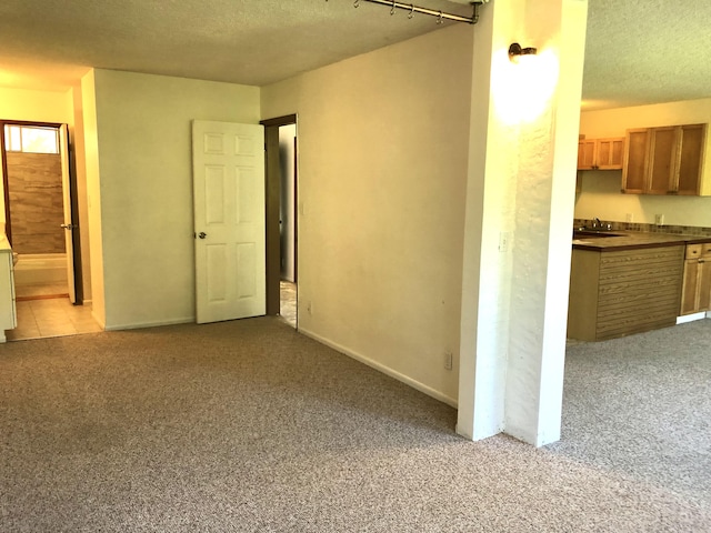 360 Kauila St Unit 203, Hilo, HI 96720 - spare room featuring light carpet, a textured ceiling, and baseboards