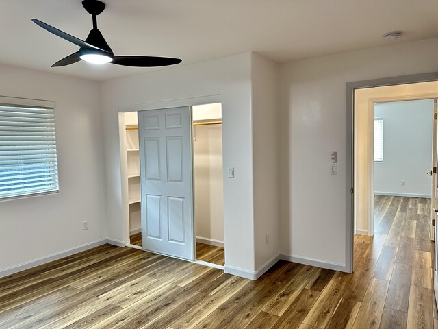 64-5304 Puu Nani Dr, Kamuela, HI 96743 - unfurnished bedroom featuring wood finished floors, multiple windows, ceiling fan, and a closet