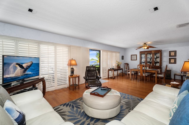 75-6082 Alii Dr Unit B236, Kailua-Kona, HI 96740 - living room featuring a ceiling fan, wood finished floors, and a textured ceiling