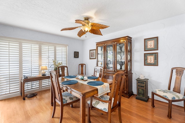 75-6082 Alii Dr Unit B236, Kailua-Kona, HI 96740 - dining room featuring ceiling fan, light wood-type flooring, and a textured ceiling