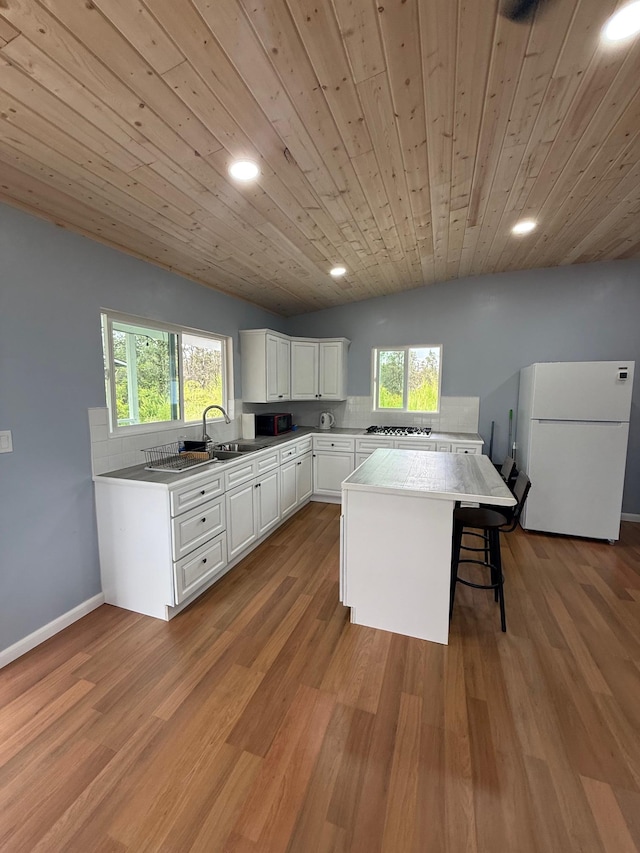 11-2828 Lehua St, Mountain View, HI 96771 - kitchen with freestanding refrigerator, a sink, white cabinets, plenty of natural light, and recessed lighting
