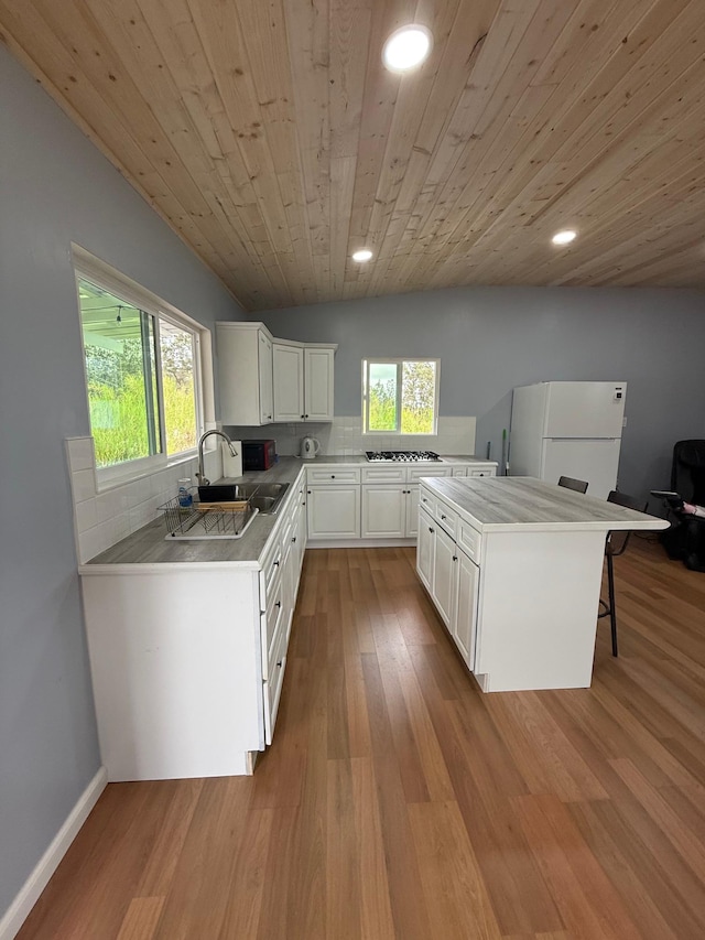 11-2828 Lehua St, Mountain View, HI 96771 - kitchen with freestanding refrigerator, a sink, backsplash, wooden ceiling, and stainless steel gas cooktop