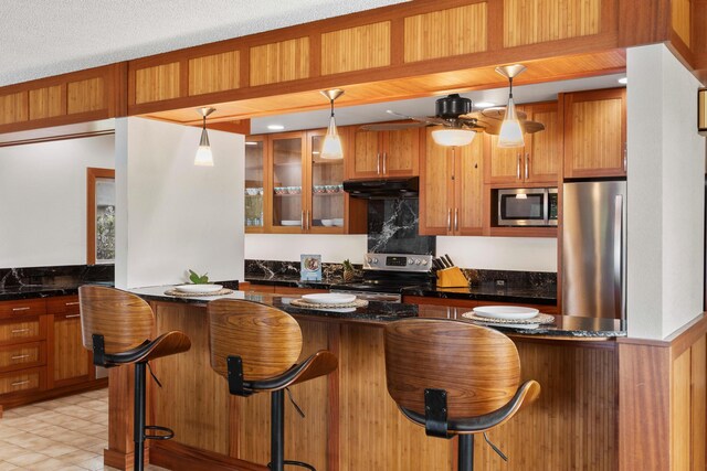 73-4332 Imo Pl, Kailua-Kona, HI 96740 - kitchen with appliances with stainless steel finishes, under cabinet range hood, and brown cabinets