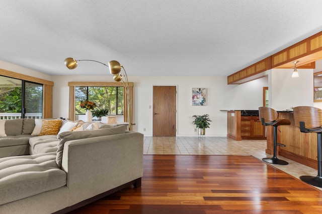 73-4332 Imo Pl, Kailua-Kona, HI 96740 - living room featuring a bar, a textured ceiling, and light wood-type flooring