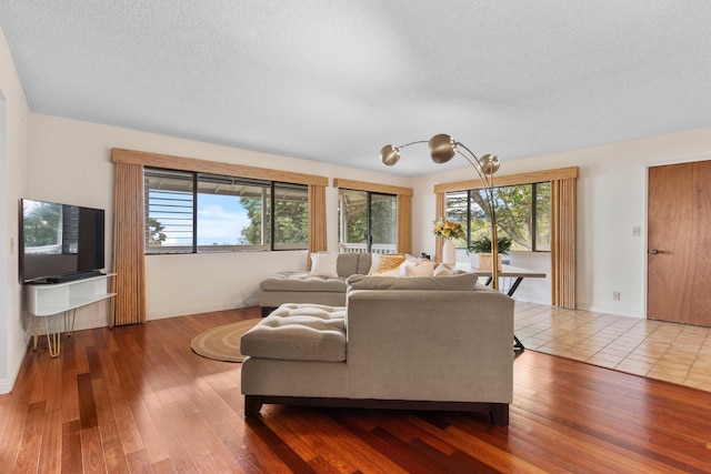 73-4332 Imo Pl, Kailua-Kona, HI 96740 - living area featuring healthy amount of natural light, wood finished floors, and a textured ceiling