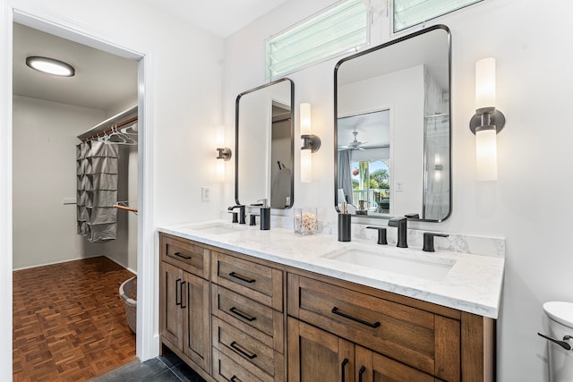 36-2333 Old Mamalahoa Hwy, Laupahoehoe, HI 96764 - bathroom with double vanity, toilet, and ceiling fan