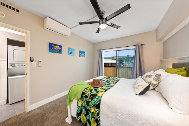 75-5719 Alii Dr Unit 321, Kailua-Kona, HI 96740 - bedroom featuring estacked washer and dryer, a wall mounted AC, light carpet, and a ceiling fan