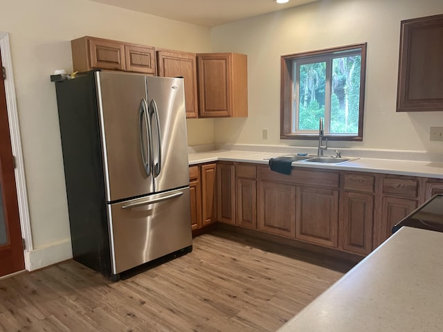 1370 Honoohala Pl, Kapaa, HI 96746 - kitchen featuring freestanding refrigerator, a sink, light wood finished floors, brown cabinets, and light countertops
