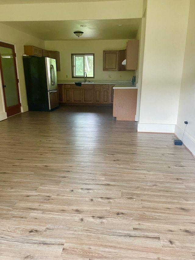1370 Honoohala Pl, Kapaa, HI 96746 - kitchen with freestanding refrigerator, a sink, light wood finished floors, light countertops, and baseboards