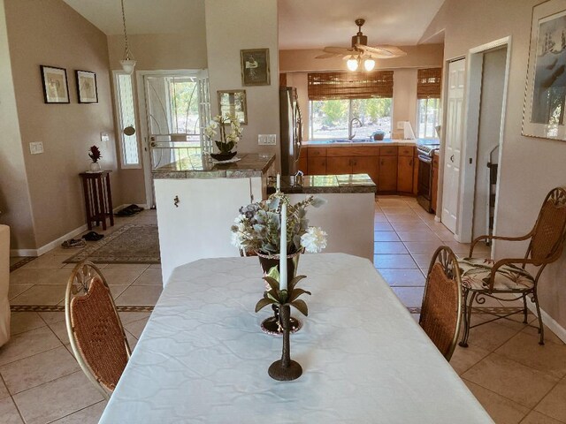 15-1500 10th Ave, Keaau, HI 96749 - dining area featuring light tile patterned floors, ceiling fan, baseboards, and vaulted ceiling