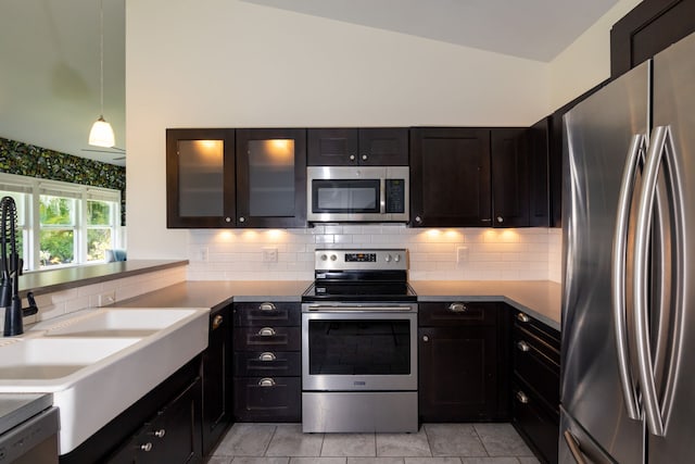 75-679 Kuahiwi Pl, Kailua-Kona, HI 96740 - kitchen with stainless steel appliances, decorative backsplash, decorative light fixtures, glass insert cabinets, and vaulted ceiling