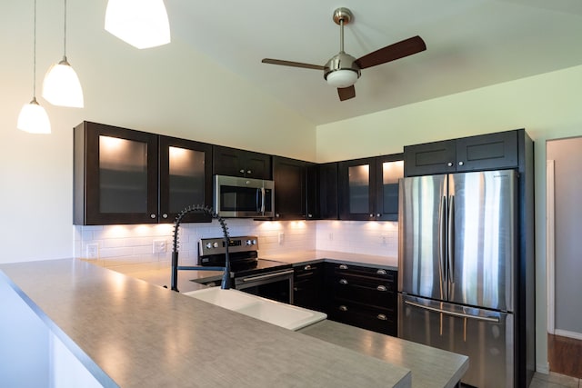 75-679 Kuahiwi Pl, Kailua-Kona, HI 96740 - kitchen with stainless steel appliances, decorative backsplash, a ceiling fan, a peninsula, and high vaulted ceiling