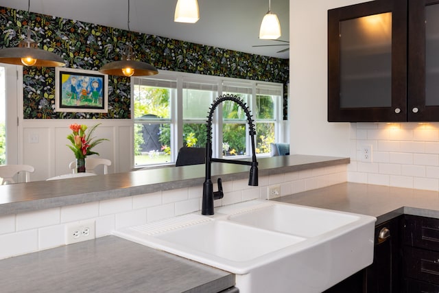 75-679 Kuahiwi Pl, Kailua-Kona, HI 96740 - kitchen with backsplash, glass insert cabinets, pendant lighting, wallpapered walls, and dark brown cabinets