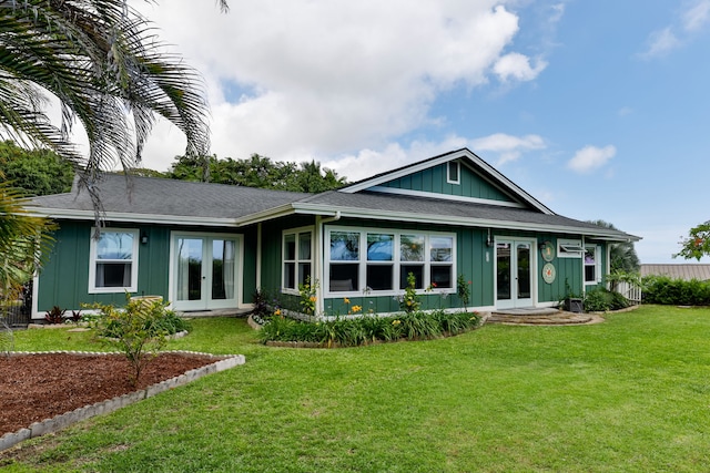 75-679 Kuahiwi Pl, Kailua-Kona, HI 96740 - rear view of house with french doors, board and batten siding, and a yard