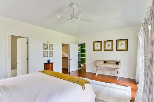 75-679 Kuahiwi Pl, Kailua-Kona, HI 96740 - bedroom with wood finished floors, a walk in closet, vaulted ceiling, a ceiling fan, and a closet