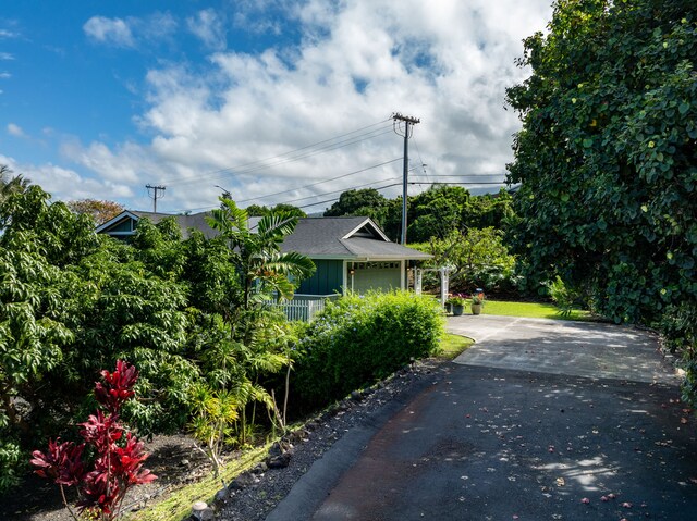 75-679 Kuahiwi Pl, Kailua-Kona, HI 96740 - view of home's exterior featuring asphalt driveway and a garage