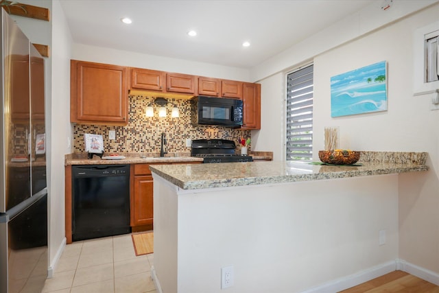 75-5873 Walua Rd Unit 312, Kailua-Kona, HI 96740 - kitchen with black appliances, a peninsula, tasteful backsplash, brown cabinetry, and recessed lighting