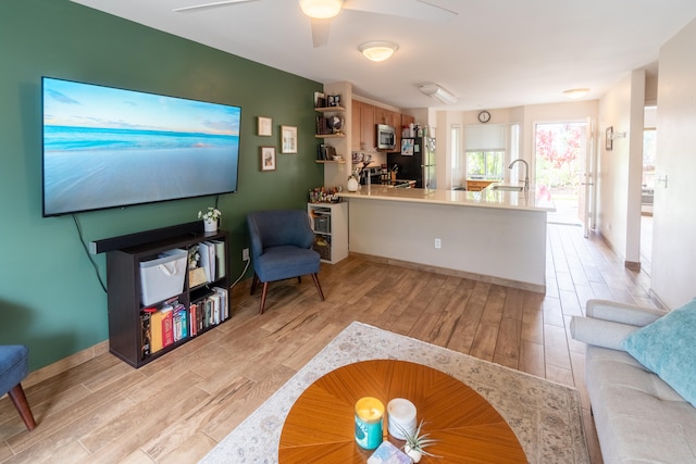 75-6081 Alii Dr Unit Kk102, Kailua-Kona, HI 96740 - living area featuring light wood finished floors and a ceiling fan
