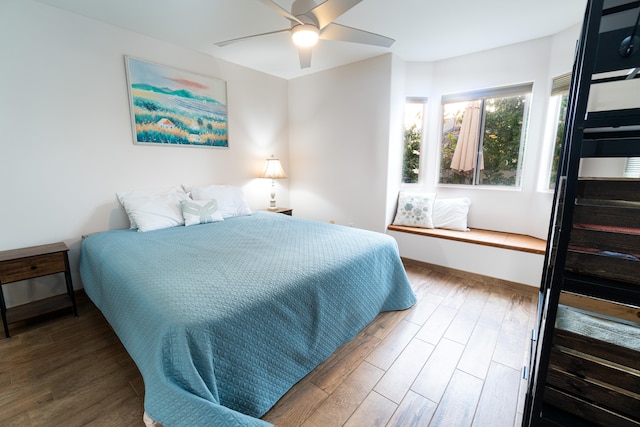 75-6081 Alii Dr Unit Kk102, Kailua-Kona, HI 96740 - bedroom with wood finished floors, a ceiling fan, and baseboards