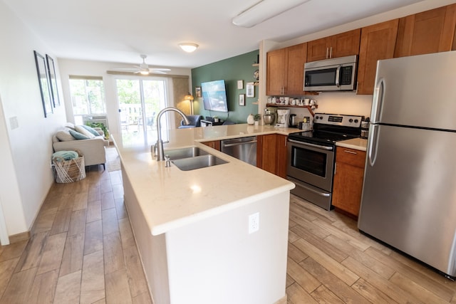 75-6081 Alii Dr Unit Kk102, Kailua-Kona, HI 96740 - kitchen featuring appliances with stainless steel finishes, a sink, open floor plan, and a peninsula