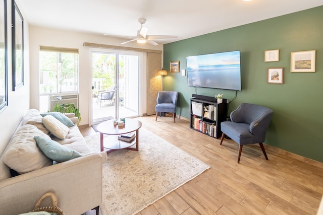 75-6081 Alii Dr Unit Kk102, Kailua-Kona, HI 96740 - living room with light wood finished floors, ceiling fan, and baseboards