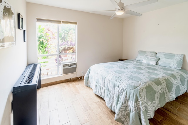 75-6081 Alii Dr Unit Kk102, Kailua-Kona, HI 96740 - bedroom with light wood-style floors, cooling unit, and ceiling fan