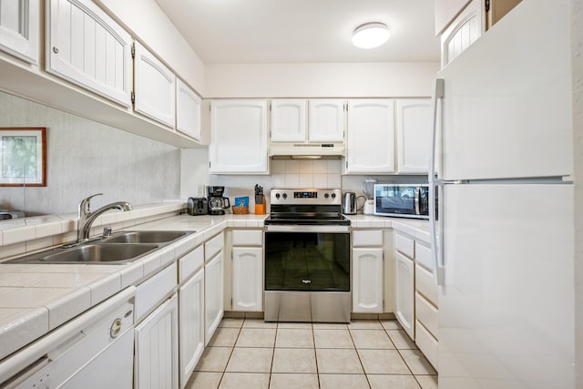 410 Papaloa Rd Unit 225, Kapaa, HI 96746 - kitchen with stainless steel appliances, under cabinet range hood, white cabinetry, and tile counters