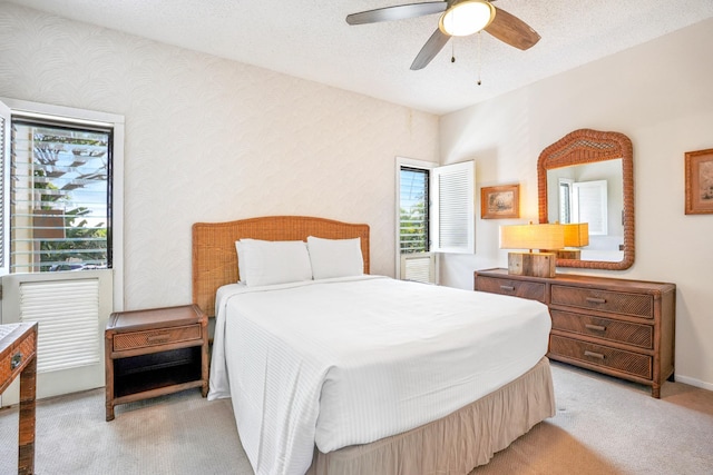410 Papaloa Rd Unit 225, Kapaa, HI 96746 - bedroom featuring light colored carpet, multiple windows, and a ceiling fan