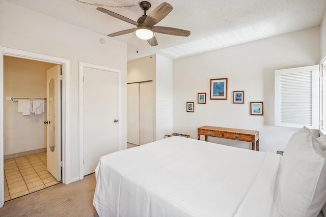 410 Papaloa Rd Unit 225, Kapaa, HI 96746 - bedroom with light colored carpet, a ceiling fan, and light tile patterned floors