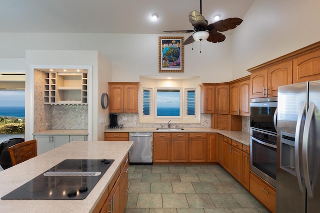 76-987 Aeo St, Kailua-Kona, HI 96740 - kitchen with stainless steel appliances, a sink, backsplash, ceiling fan, and brown cabinets