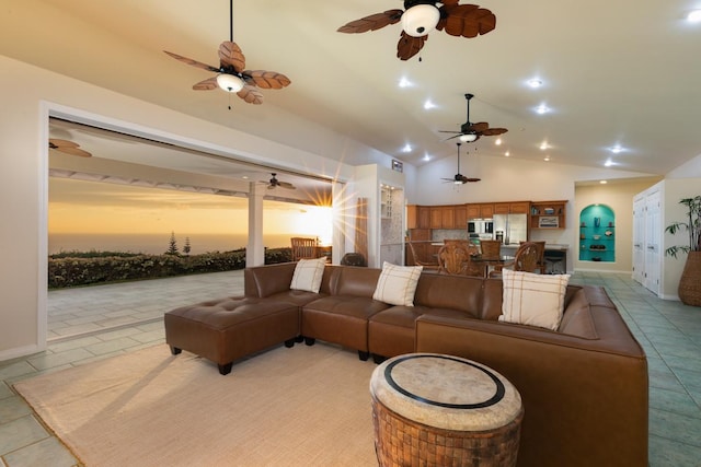 76-987 Aeo St, Kailua-Kona, HI 96740 - living room featuring vaulted ceiling, light tile patterned floors, a ceiling fan, and baseboards