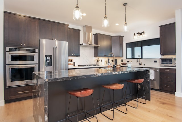 75-650 Halewili Pl, Kailua-Kona, HI 96725 - kitchen featuring appliances with stainless steel finishes, wall chimney range hood, a breakfast bar area, dark brown cabinetry, and recessed lighting