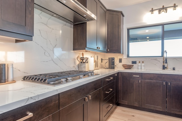 75-650 Halewili Pl, Kailua-Kona, HI 96725 - kitchen with custom exhaust hood, stainless steel gas stovetop, tasteful backsplash, and dark brown cabinetry