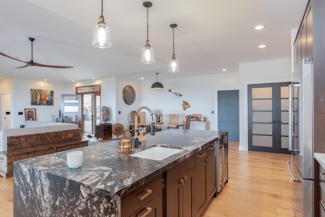 75-650 Halewili Pl, Kailua-Kona, HI 96725 - kitchen featuring freestanding refrigerator, light wood-type flooring, french doors, dark brown cabinetry, and recessed lighting