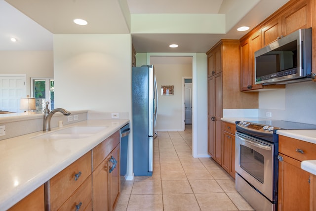 75-5614-R Hienaloli Rd, Kailua-Kona, HI 96740 - kitchen with appliances with stainless steel finishes, brown cabinets, light countertops, light tile patterned floors, and recessed lighting