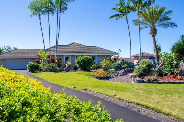 75-5614-R Hienaloli Rd, Kailua-Kona, HI 96740 - single story home with a front yard, stucco siding, a tiled roof, and an attached garage